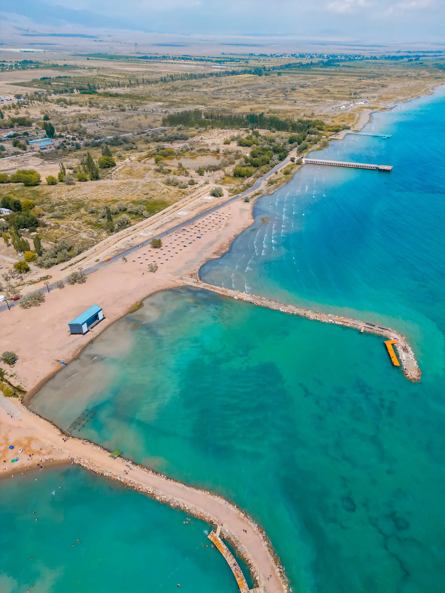 drone shot of a beach and pier on Lake Issyk-Kul, Kyrgyzstan