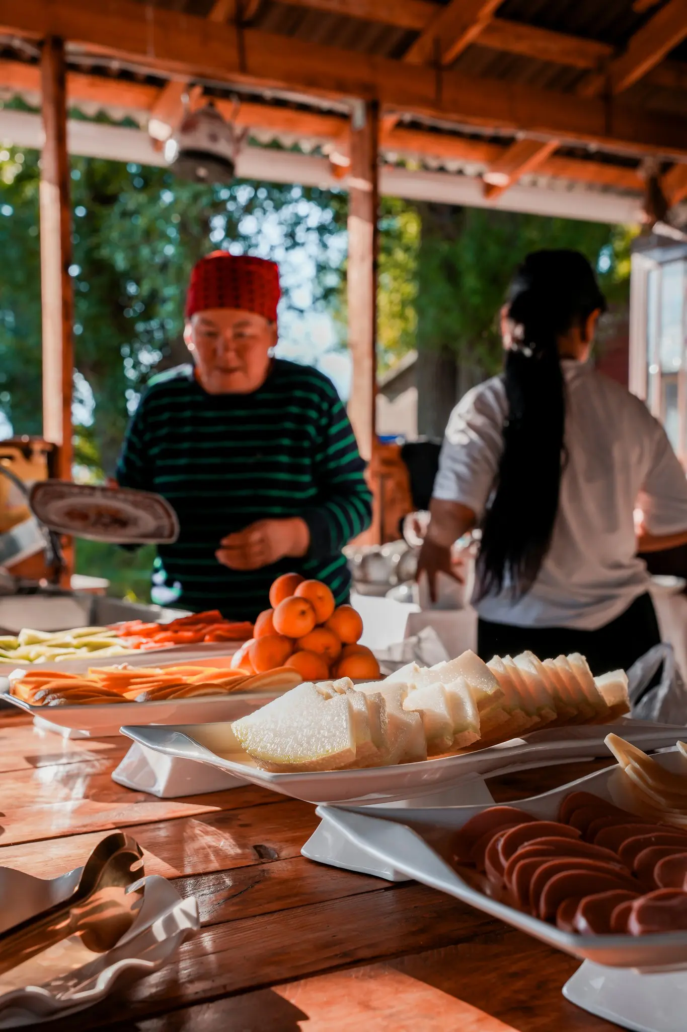people serving themselves at a buffet with fresh fruit