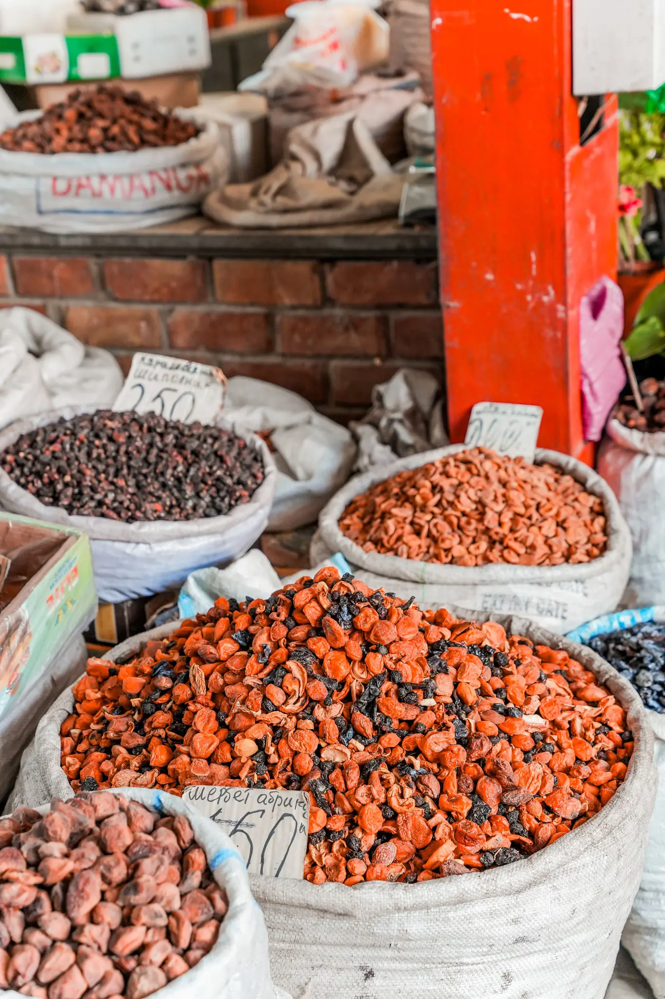 large sacks of dried fruit and nuts at a market stall