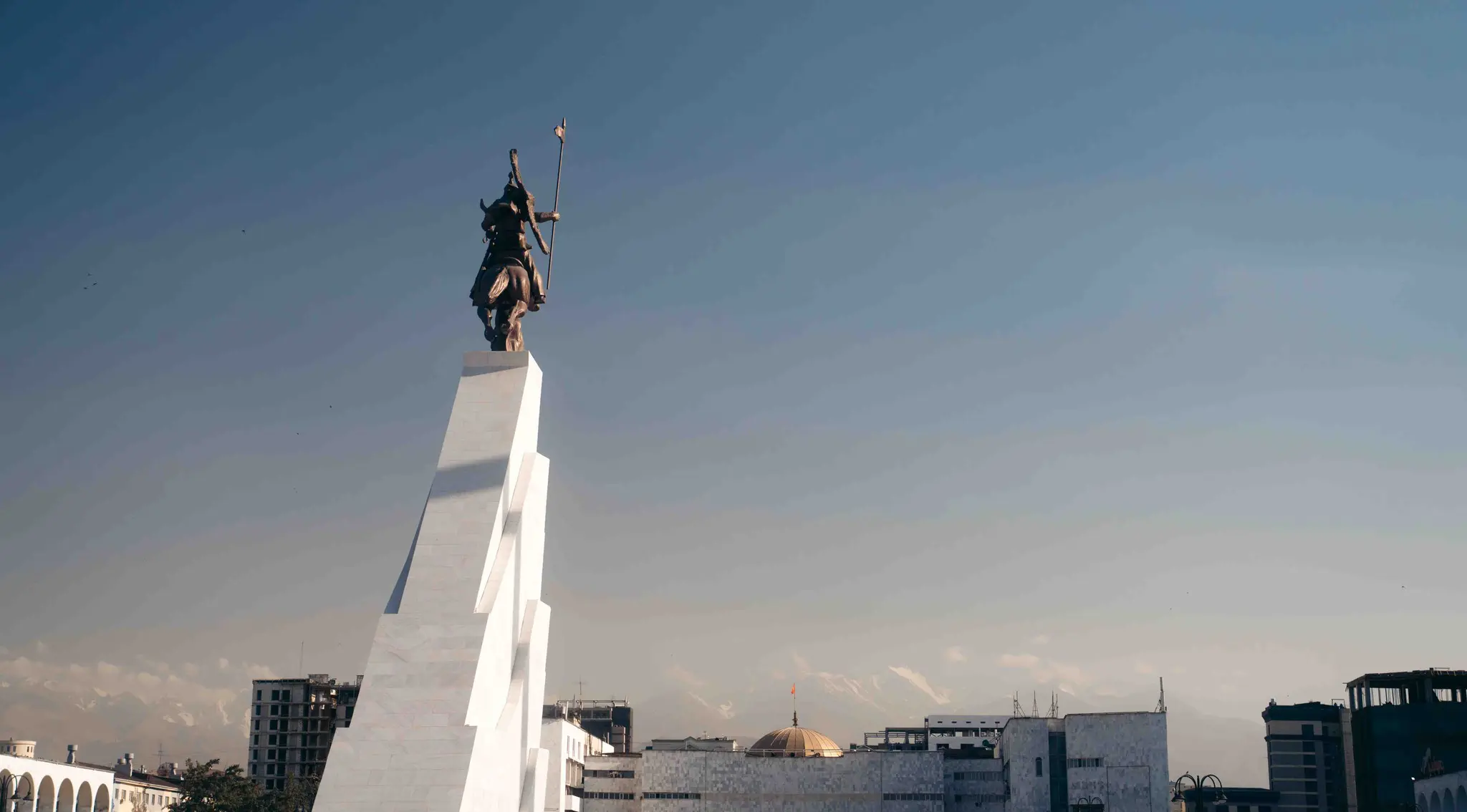 Manas statue in Bishkek, Kyrgyzstan with mountains in background