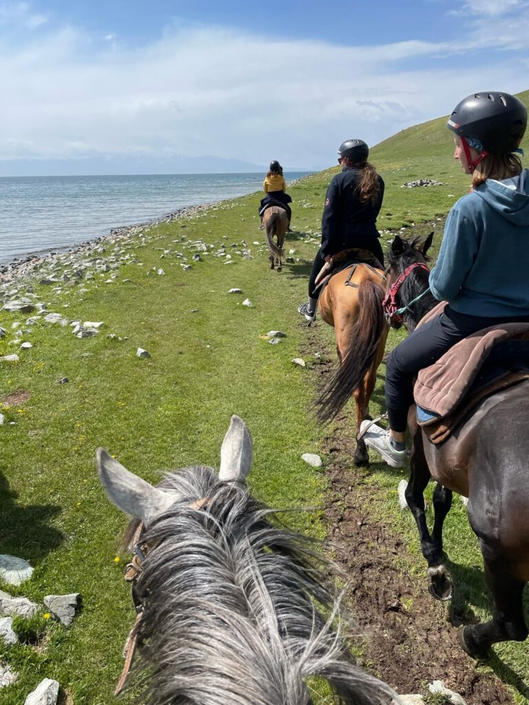 horseback riding along a lake