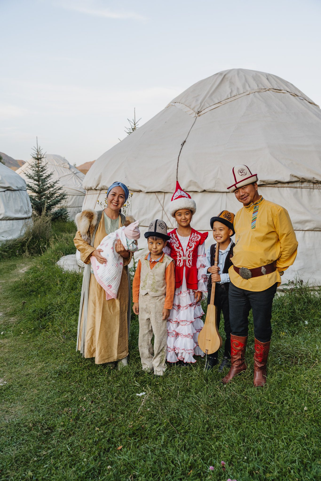 Kyrgyz family, with instruments and traditional clothes